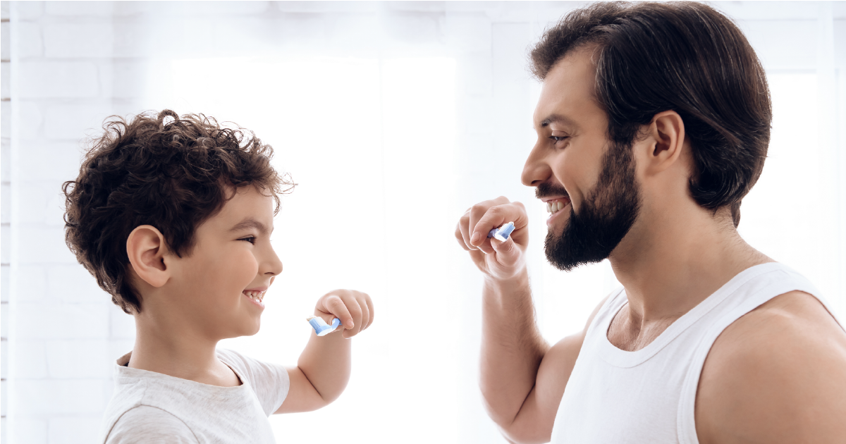 Dad and son brushing teeth
